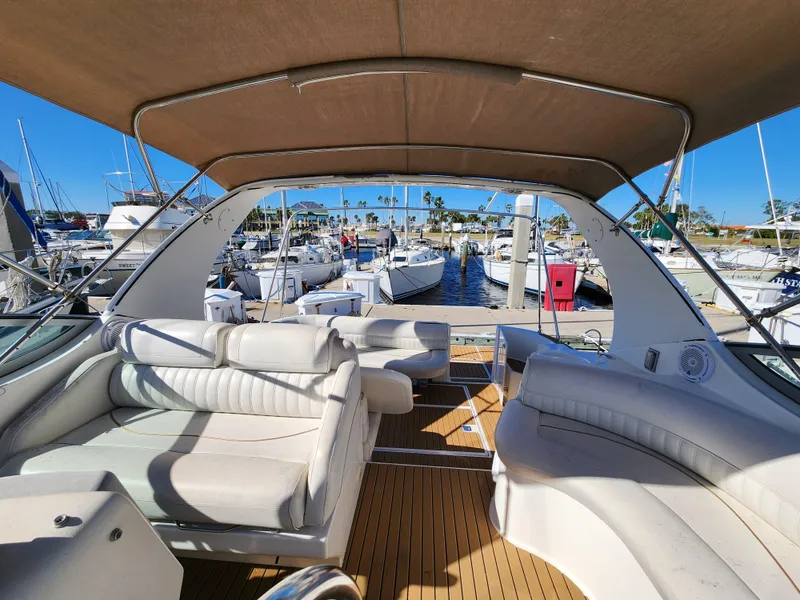 Slide: The Image of 1999 Cruisers Yachts 3375 Esprit interior with white seating at marina. - 11