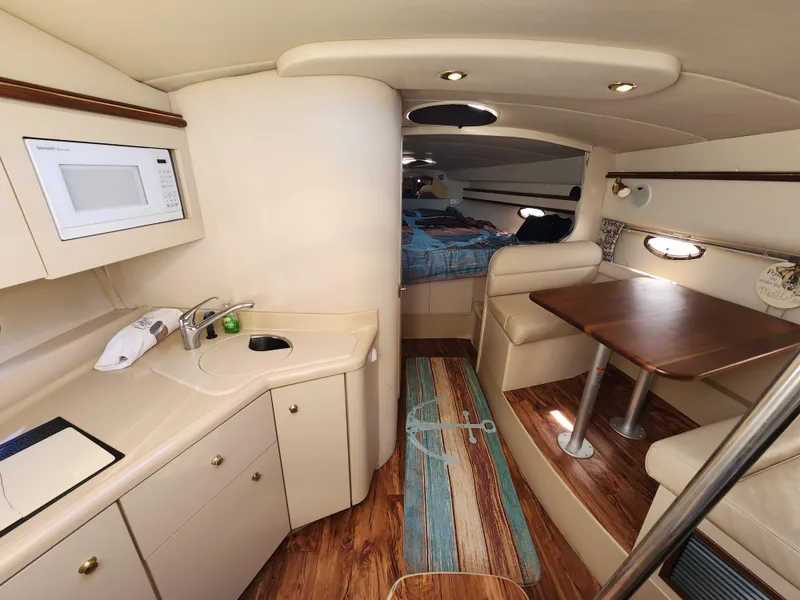 Slide: The Image of Interior of 1999 Cruisers Yachts 3375 Esprit with kitchenette and seating area. - 16