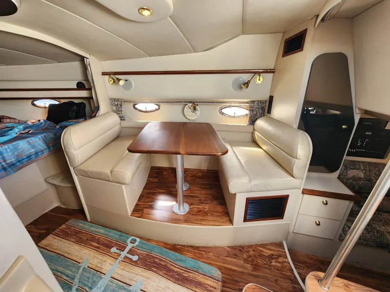 Slide: The Image of 1999 Cruisers Yachts 3375 Esprit interior with dining area and wood accents. - 19