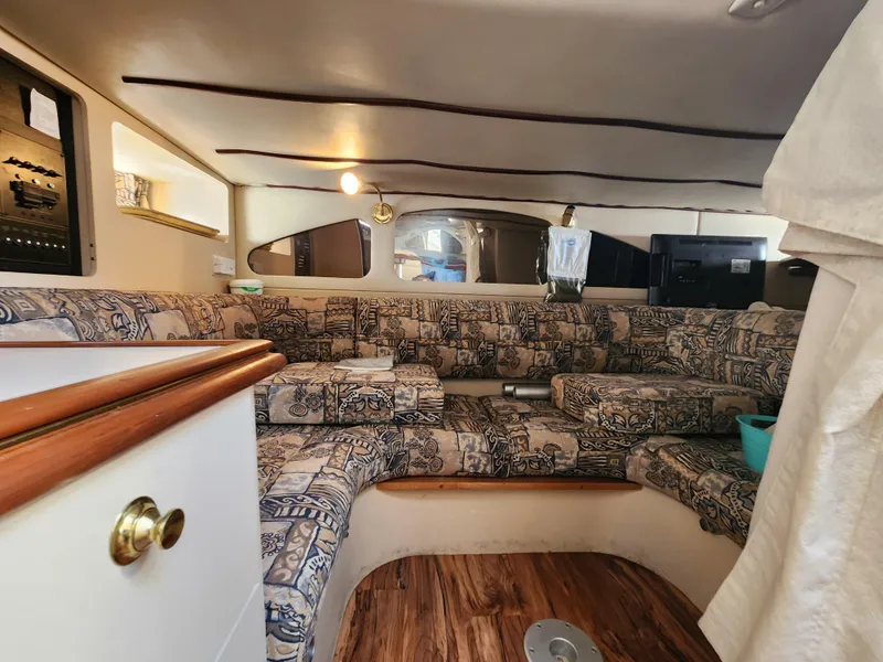 Slide: The Image of Interior of 1999 Cruisers Yachts 3375 Esprit with patterned seating and wood flooring. - 21