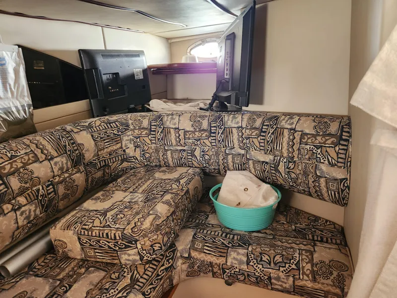 Slide: The Image of 1999 Cruisers Yachts 3375 Esprit interior with patterned seating and a TV. - 22