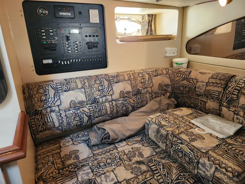 Slide: The Image of Interior of 1999 Cruisers Yachts 3375 Esprit with patterned seating and control panel. - 23