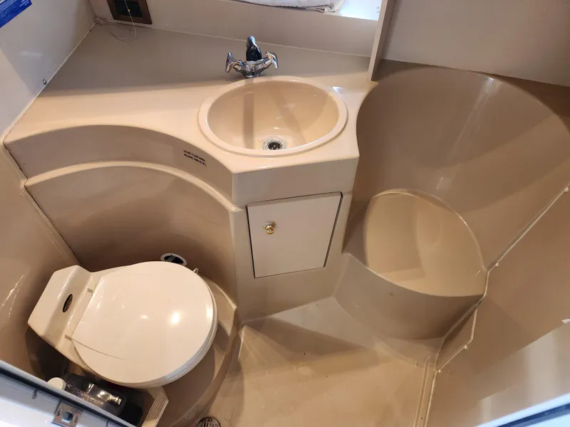 Slide: The Image of 1999 Cruisers Yachts 3375 Esprit bathroom with sink, toilet, and shower area. - 24