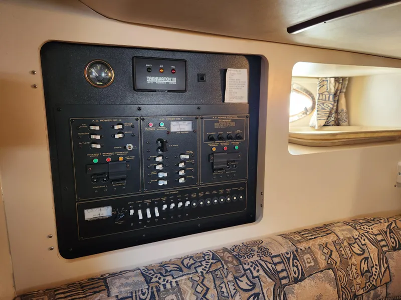 Slide: The Image of Electrical control panel inside 1999 Cruisers Yachts 3375 Esprit, featuring switches and gauges. - 25
