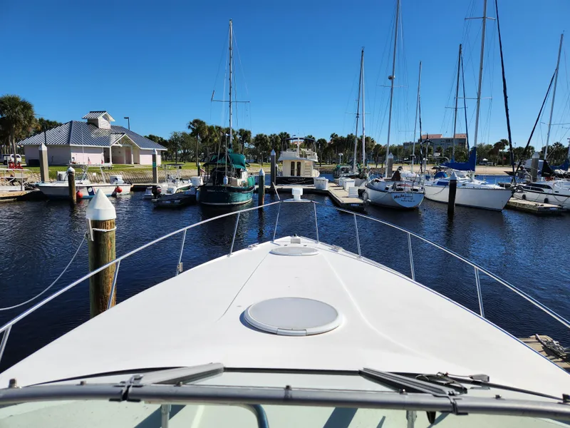Slide: The Image of 1999 Cruisers Yachts 3375 Esprit docked in a marina with sailboats. - 26