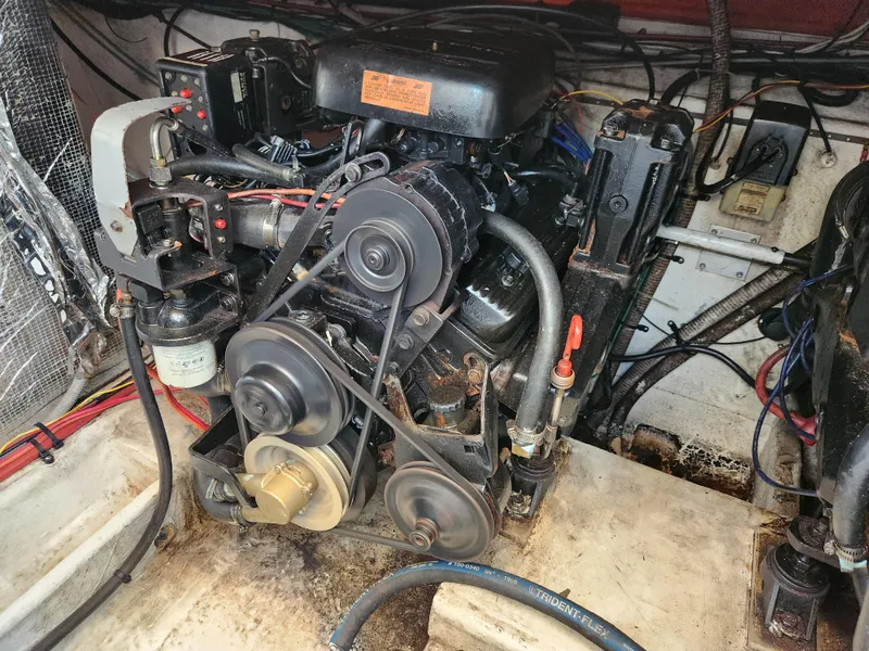 Slide: The Image of Engine compartment of a 1999 Cruisers Yachts 3375 Esprit, showcasing mechanical components and wiring. - 29
