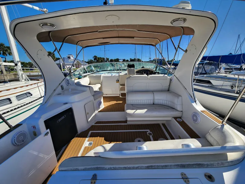Slide: The Image of 1999 Cruisers Yachts 3375 Esprit interior with seating and canopy at marina. - 4