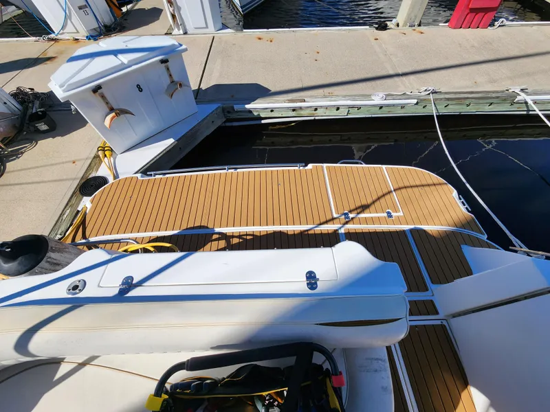 Slide: The Image of 1999 Cruisers Yachts 3375 Esprit docked, featuring teak deck and marina view. - 6