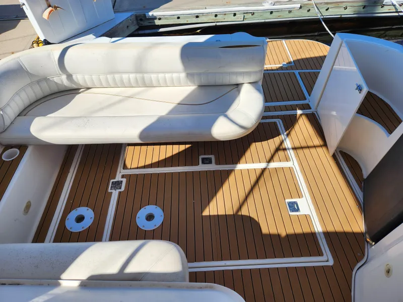 Slide: The Image of 1999 Cruisers Yachts 3375 Esprit interior with white seating and teak flooring. - 8