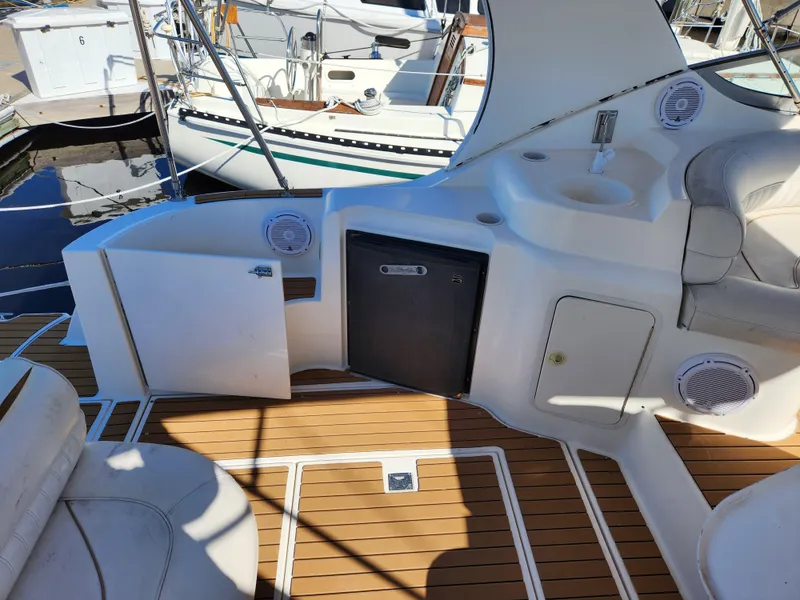 Slide: The Image of 1999 Cruisers Yachts 3375 Esprit interior with seating, sink, and storage. - 9