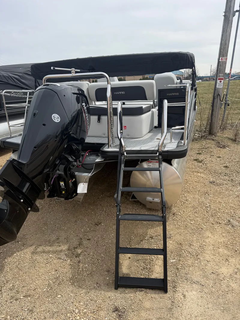 Slide: The Image of 2025 Harris Cruiser 210 pontoon boat with outboard motor and ladder. - 12