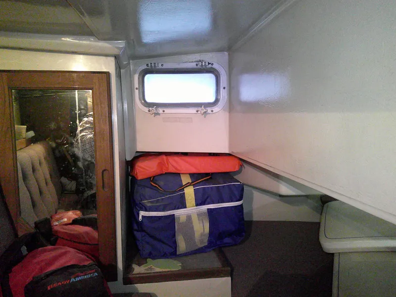 Slide: The Image of Interior of a 1984 Catalina 36' sloop with storage bags and a small window. - 24