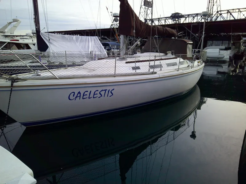 Slide: The Image of 1984 Catalina 36' sloop named "Caelestis" docked in a marina. - 25