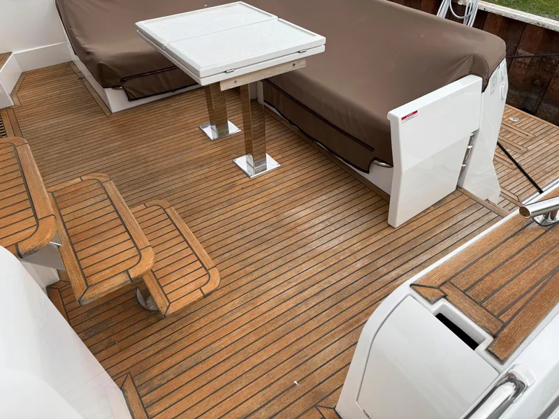 Slide: The Image of Luxury Galeon 560 Sky yacht deck with wooden flooring and seating, 2018 model. - 12