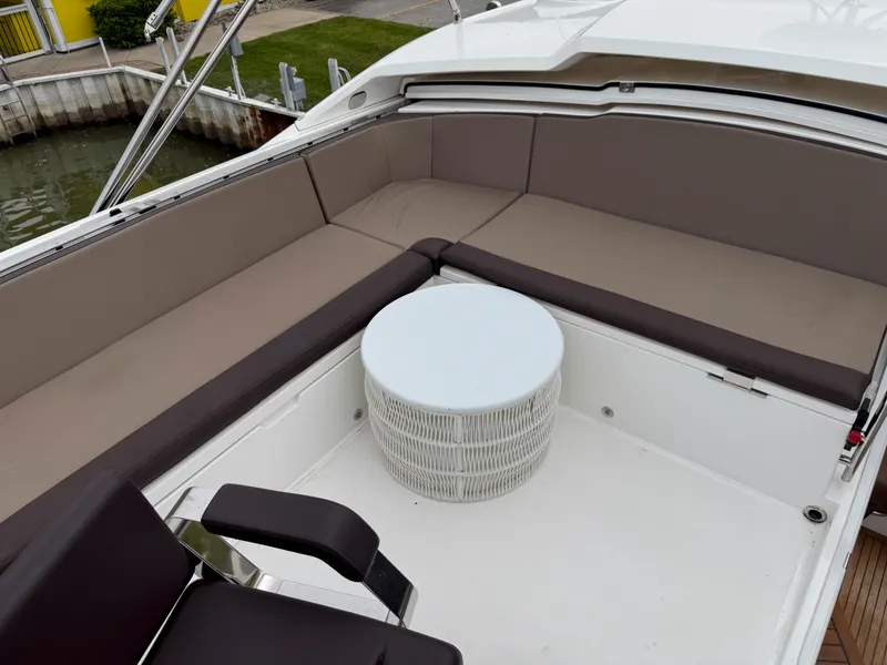 Slide: The Image of 2018 Galeon 560 Sky yacht with spacious seating and a round table on deck. - 14