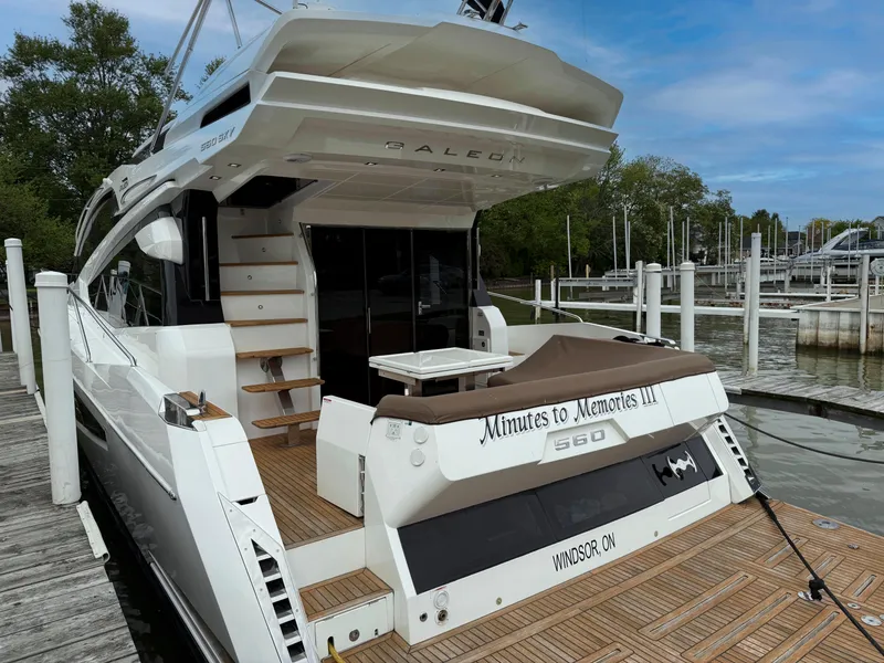 Slide: The Image of 2018 Galeon 560 Sky yacht docked, featuring elegant design and spacious deck. - 2