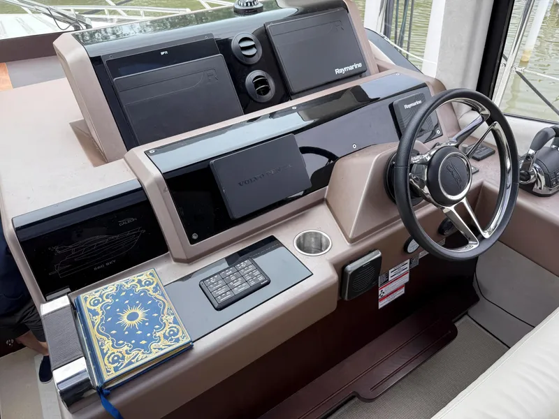 Slide: The Image of Helm of 2018 Galeon 560 Sky yacht with navigation equipment and decorative book. - 21