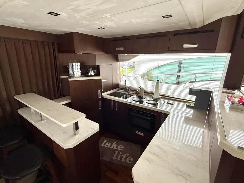 Slide: The Image of Luxurious kitchen interior of 2018 Galeon 560 Sky yacht with modern amenities and sleek design. - 22