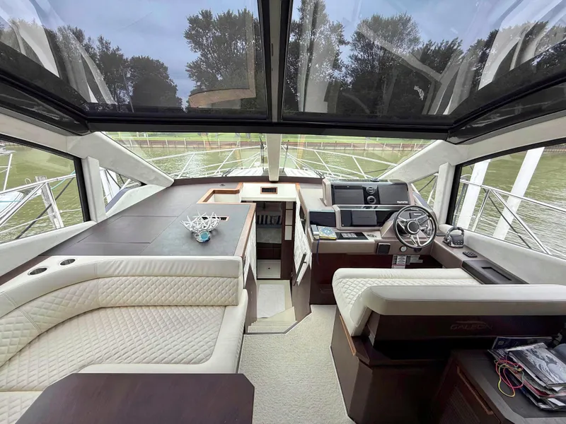 Slide: The Image of Luxurious interior of 2018 Galeon 560 Sky yacht with panoramic windows and elegant seating. - 26