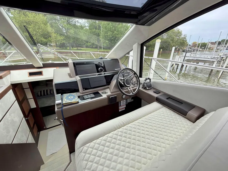 Slide: The Image of Interior view of 2018 Galeon 560 Sky yacht cockpit with modern controls and steering wheel. - 27