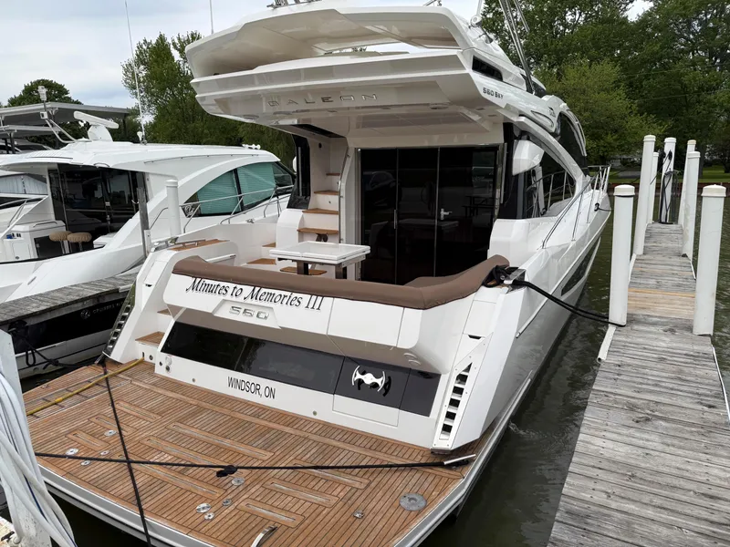 Slide: The Image of 2018 Galeon 560 Sky yacht docked, featuring spacious deck and elegant design. - 3