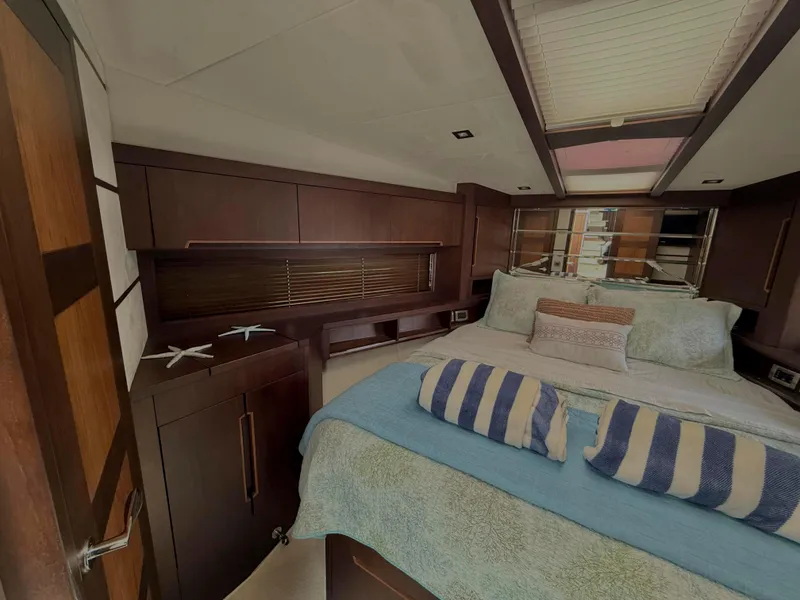 Slide: The Image of Luxurious bedroom interior of 2018 Galeon 560 Sky yacht with elegant bedding and wood finishes. - 31
