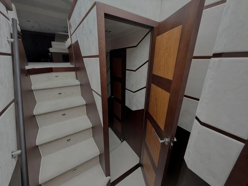 Slide: The Image of Interior of 2018 Galeon 560 Sky yacht, featuring stairs and wooden door. - 32