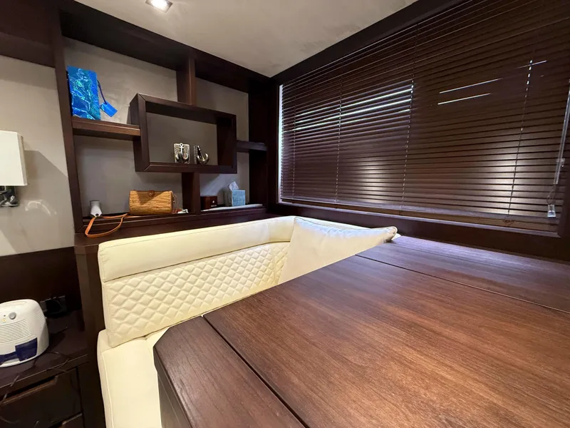 Slide: The Image of Interior of 2018 Galeon 560 Sky yacht with wooden table and cream seating. - 36