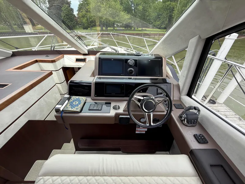 Slide: The Image of Helm of 2018 Galeon 560 Sky yacht with modern controls and navigation systems. - 42