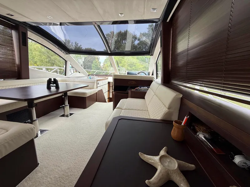 Slide: The Image of Luxurious interior of 2018 Galeon 560 Sky yacht with modern seating and panoramic windows. - 43
