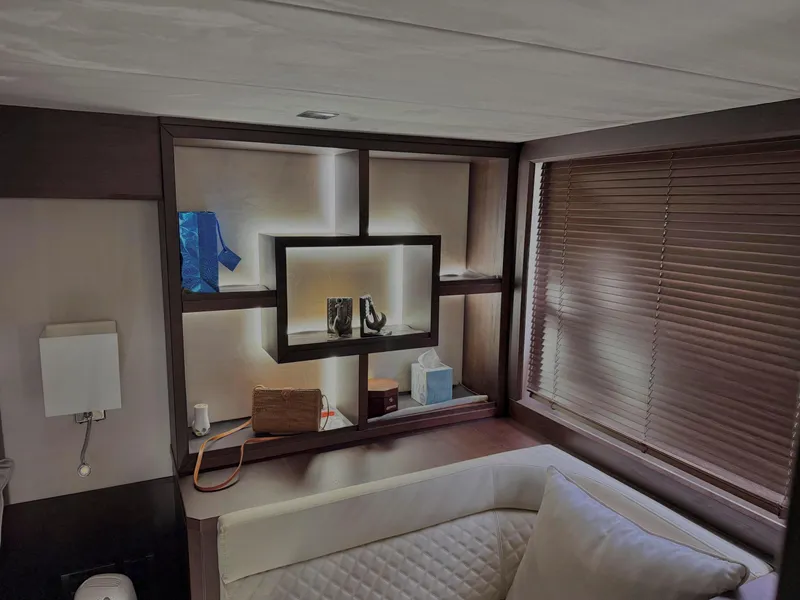 Slide: The Image of Interior of 2018 Galeon 560 Sky yacht with modern shelving and cozy seating area. - 45