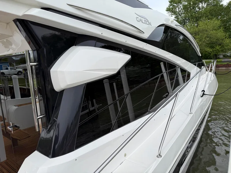 Slide: The Image of 2018 Galeon 560 Sky yacht docked, showcasing sleek design and modern features. - 5