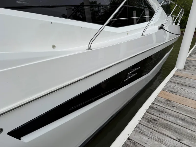 Slide: The Image of 2018 Galeon 560 Sky yacht docked, showcasing sleek white exterior and modern design. - 6