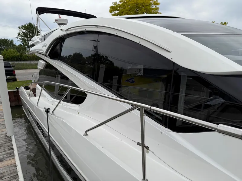 Slide: The Image of 2018 Galeon 560 Sky yacht docked, showcasing sleek design and modern features. - 9