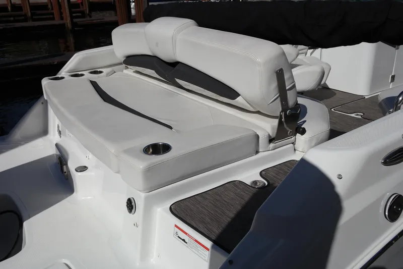 Slide: The Image of 2022 Four Winns HD3 boat with white seating and cup holder on deck. - 10