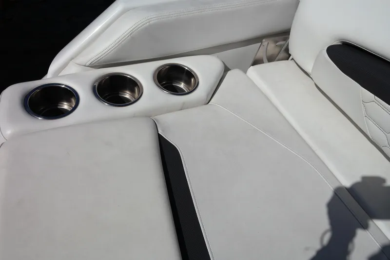 Slide: The Image of 2022 Four Winns HD3 boat interior with white seating and cup holders. - 11