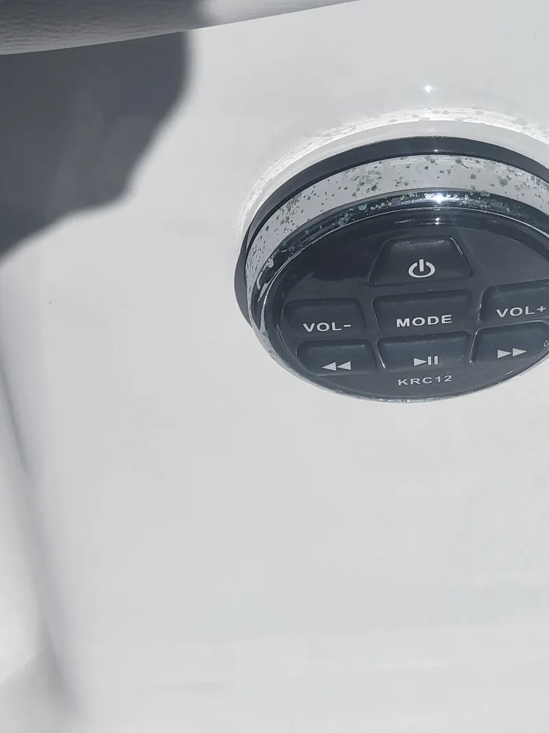 Slide: The Image of 2022 Four Winns HD3 boat audio control panel with volume and mode buttons. - 13