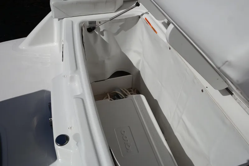 Slide: The Image of 2022 Four Winns HD3 boat storage compartment with open lid. - 17