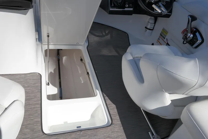 Slide: The Image of 2022 Four Winns HD3 boat interior with open storage compartment and white seating. - 20