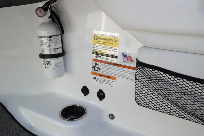 Slide: The Image of 2022 Four Winns HD3 boat interior with fire extinguisher and safety labels. - 24
