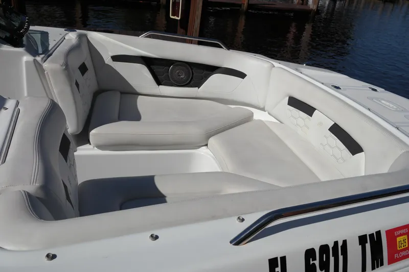 Slide: The Image of 2022 Four Winns HD3 boat with spacious white seating area by the water. - 25