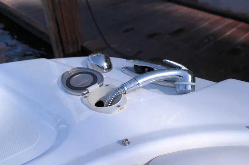 Slide: The Image of 2022 Four Winns HD3 boat with chrome fuel cap and hose on deck. - 28