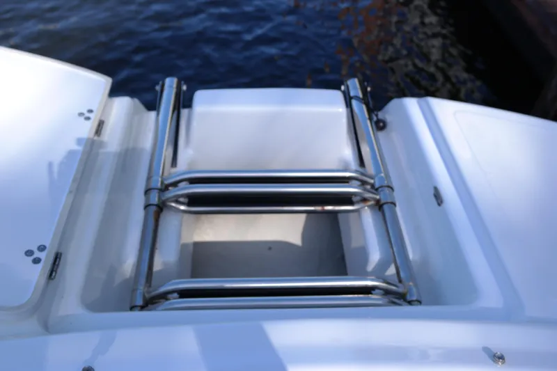 Slide: The Image of 2022 Four Winns HD3 boat ladder on deck, near water. - 30