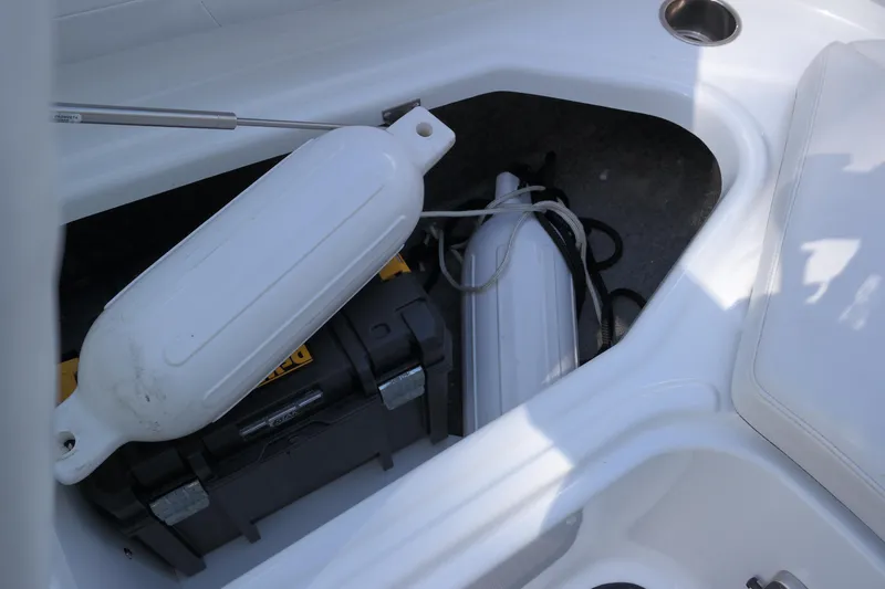 Slide: The Image of Storage compartment in 2022 Four Winns HD3 boat with fenders and toolbox. - 32