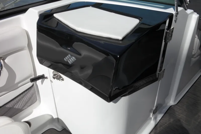Slide: The Image of 2022 Four Winns HD3 boat interior with sleek black and white console design. - 33