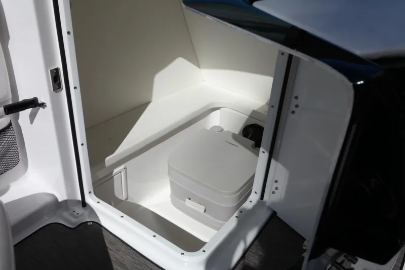 Slide: The Image of 2022 Four Winns HD3 boat interior with compact marine toilet. - 34