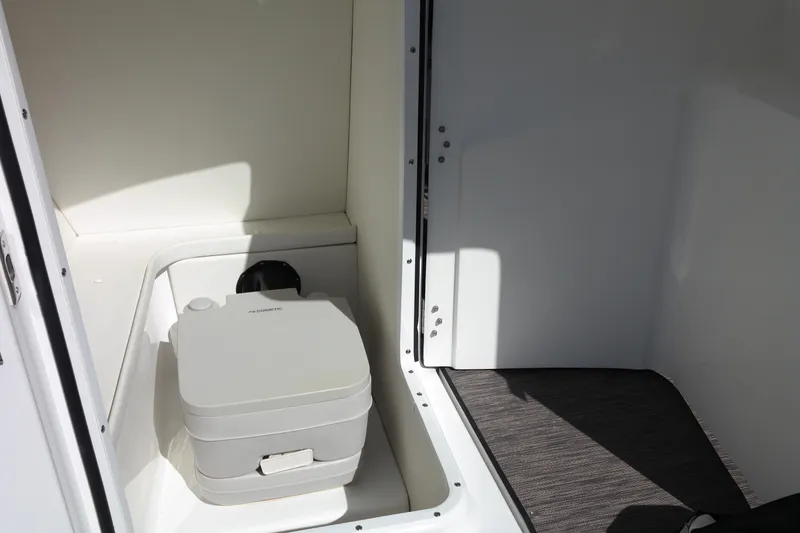 Slide: The Image of 2022 Four Winns HD3 boat interior with portable toilet. - 35