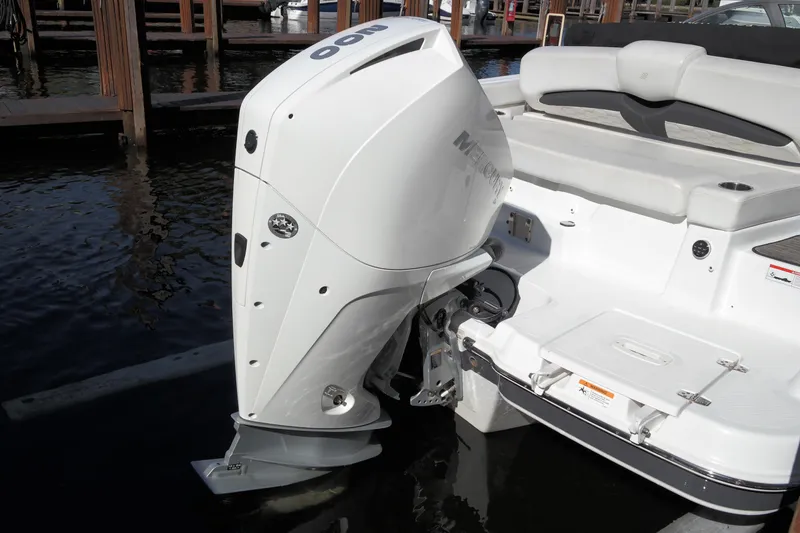 Slide: The Image of 2022 Four Winns HD3 boat with powerful outboard motor, docked in marina. - 6