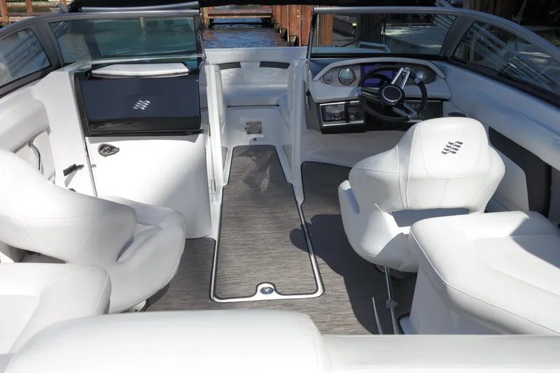 Slide: The Image of Interior of 2022 Four Winns HD3 boat with white seating and modern dashboard. - 7