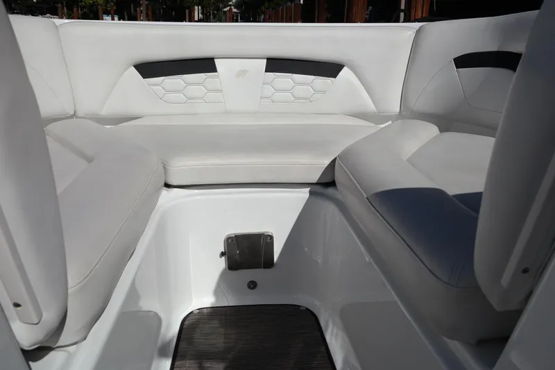 Slide: The Image of 2022 Four Winns HD3 boat interior with white cushioned seating and modern design. - 9